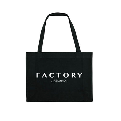 Black tote bag with 'FACTORY IRELAND' text on a white background